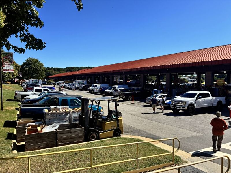 Parked vehicles beside one of the covered market buildings.