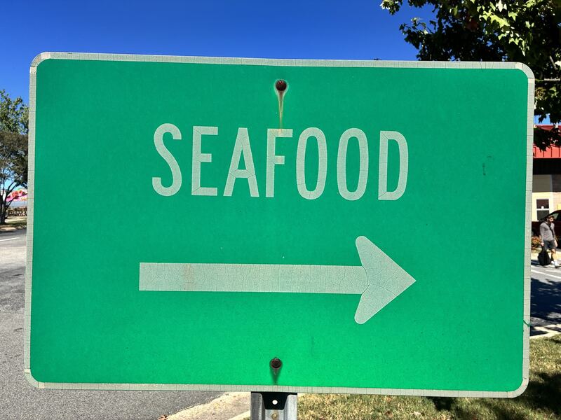 A directional sign points toward seafood.
