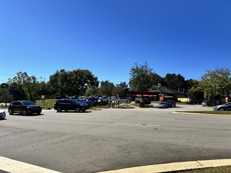 A wide view of the parking area and surrounding buildings.