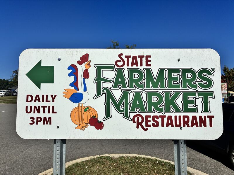A roadside sign points toward the State Farmers Market Restaurant.
