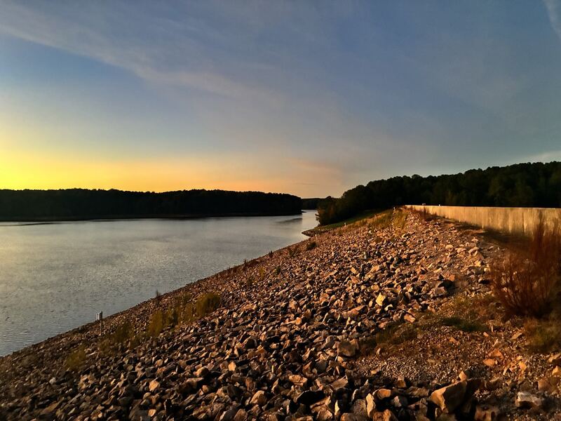 Sunset over Falls Lake and the dam’s rocky embankment