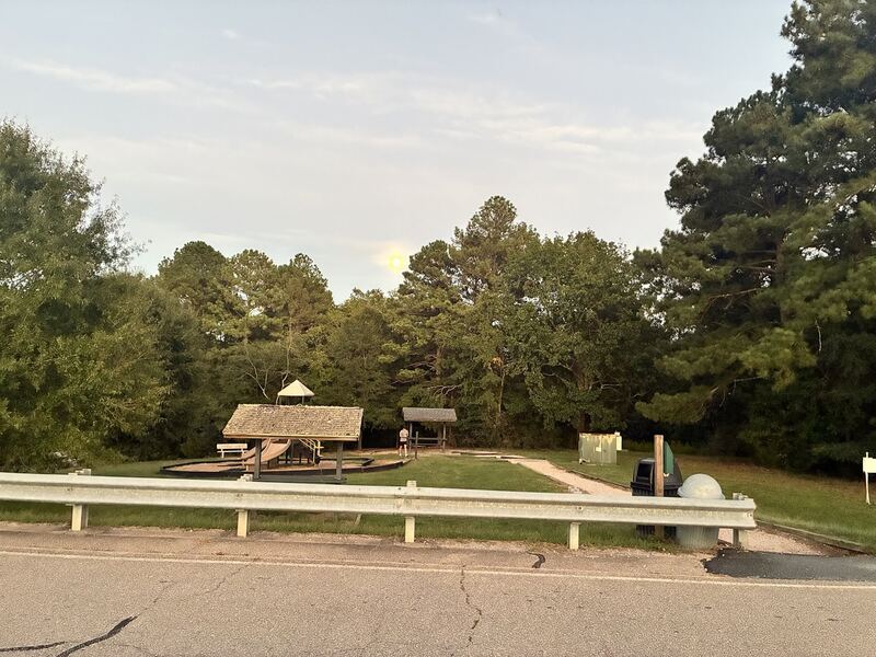 A shelter and open recreation space near the dam area.