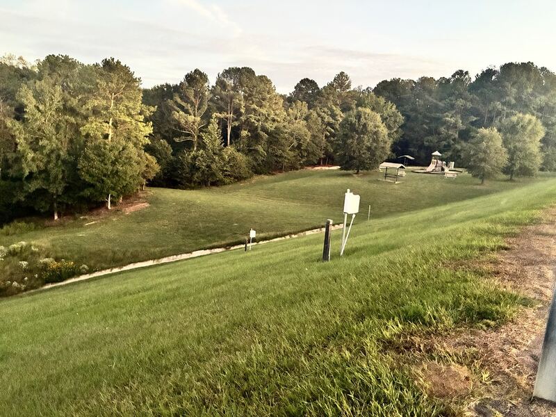 Paths and grass below the dam.