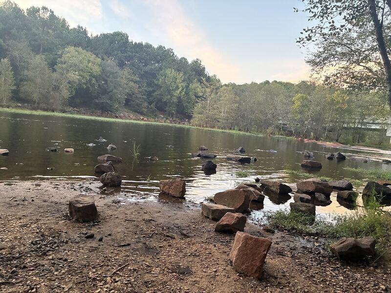 Stones and reflections below the dam.
